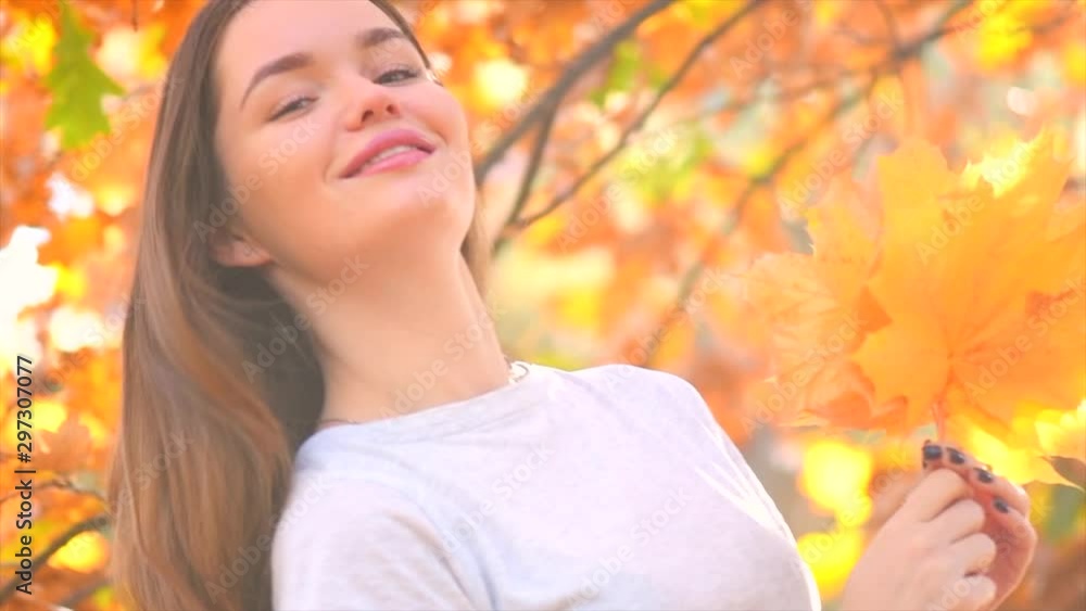 Autumn model girl posing and laughing in autumnal park with colorful leaves. Beautiful Young Woman Having Fun outdoors. Fall. Red and Yellow Leaves. Beauty of Nature. Slow Motion Shot 240 fps Autumn model girl posing and laughing in autumnal park with colorful leaves. Beautiful Young Woman Having Fun outdoors. Fall. Red and Yellow Leaves. Beauty of Nature. Slow Motion Shot 240 fps