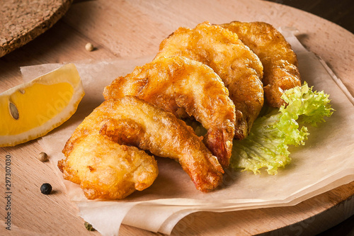 Deep Fried Shrimps on wooden board and baking paper