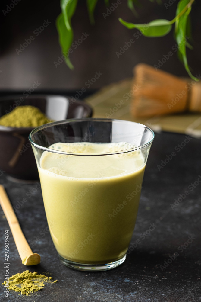 Matcha green tea latte in glass mug with whisk. Matcha green tea latte in glass mug with whisk.