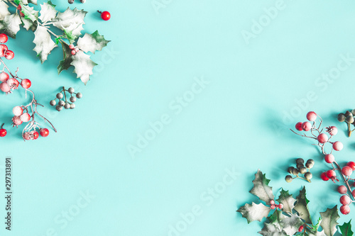 Christmas composition. Frame made of christmas plants on blue background. Flat lay, top view, copy space © Flaffy