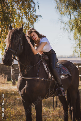 Rider elegant woman talking to her horse. Portrait of riding horse with woman . Equestrian horse with rider at nature 