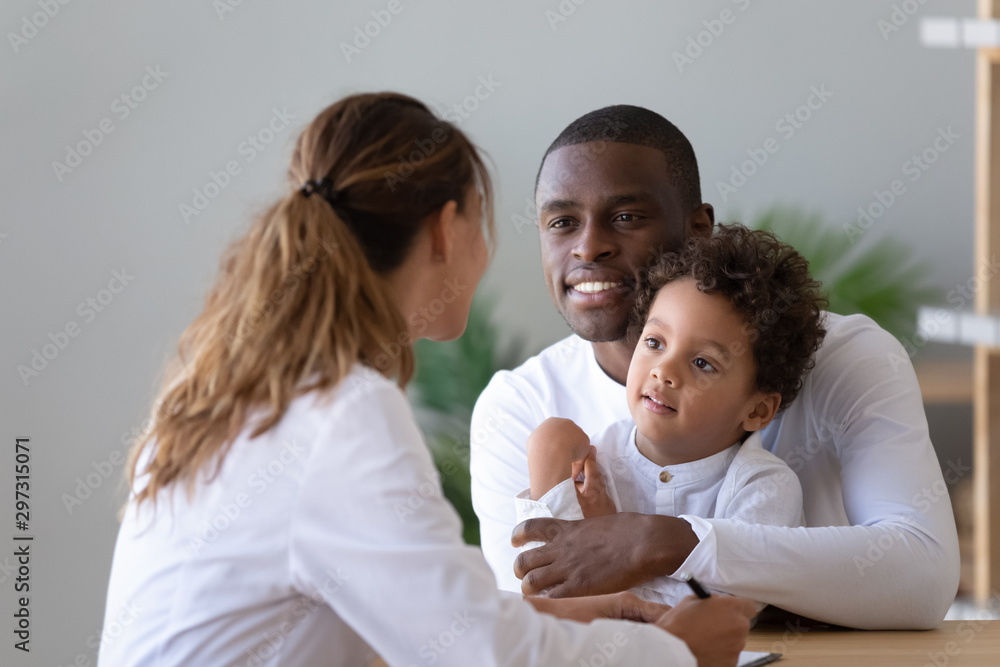 African American dad with little son visit female pediatrician African American dad with little son visit female pediatrician