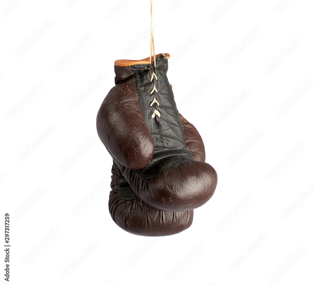 pair of very old vintage brown leather boxing gloves hanging on a rope