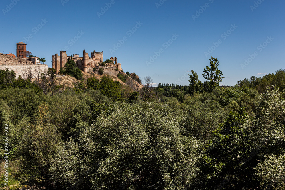 Escalona mudejar Palace over river trees landscape. Toledo, Spain.