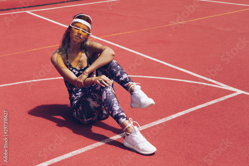 Slender girl in sportswear posing on the tennis court © nelen.ru