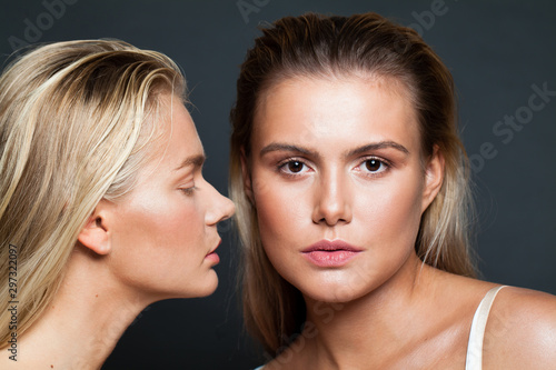 Two pretty women faces  closeup portrait