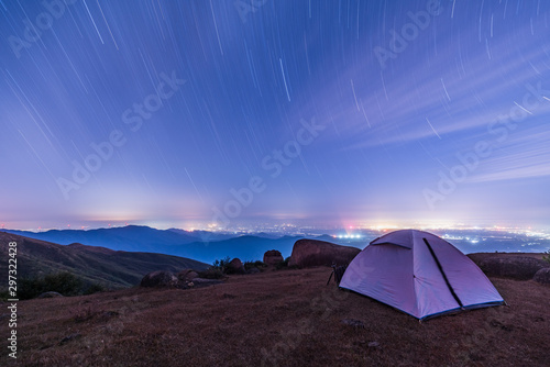 tent at sunset   Tourist hikers tent in mountains at night with stars in the sky 