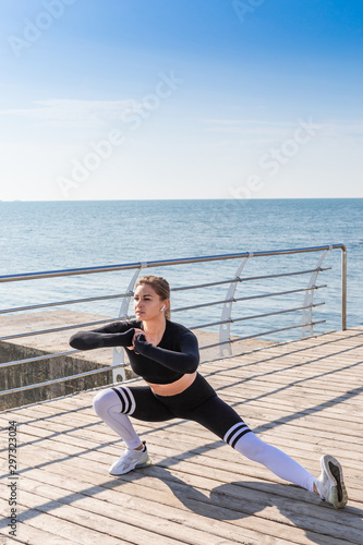 Female fitness girl model doing stretch exercising.