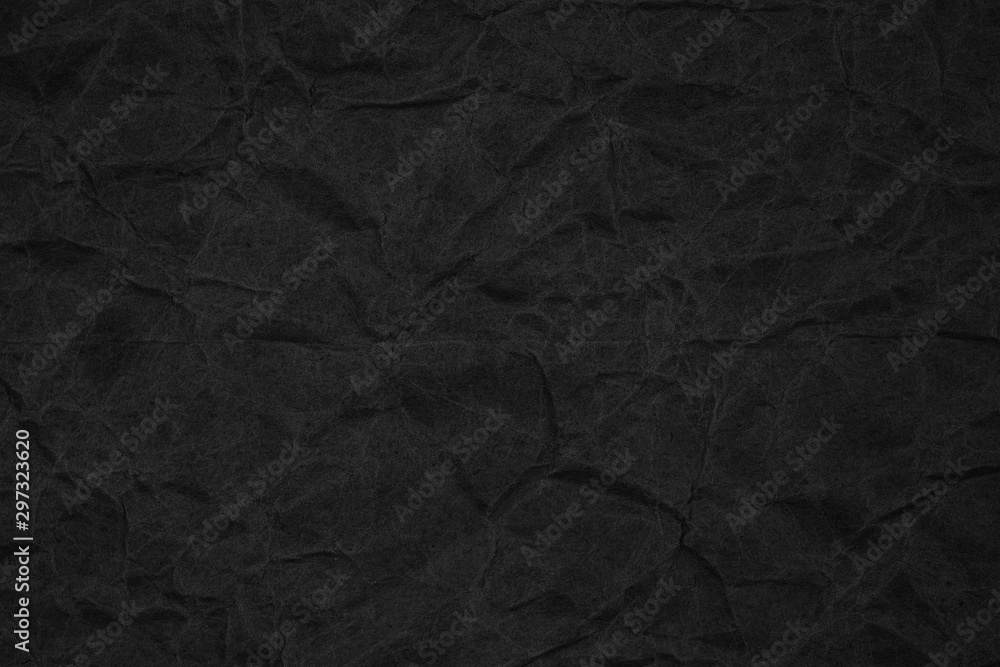 Fototapeta premium Black crumpled packaging paper background texture. Dark Kraft Paper Coarse. Wrinkled paper bag