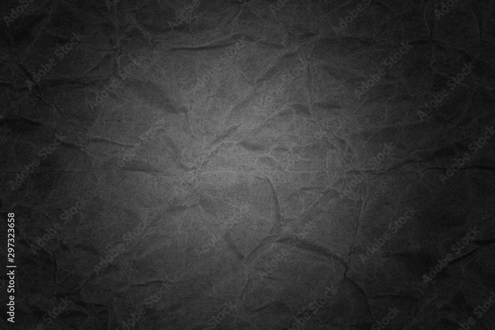 Naklejka premium Black crumpled packaging paper background texture. Dark Kraft Paper Coarse. Wrinkled paper bag