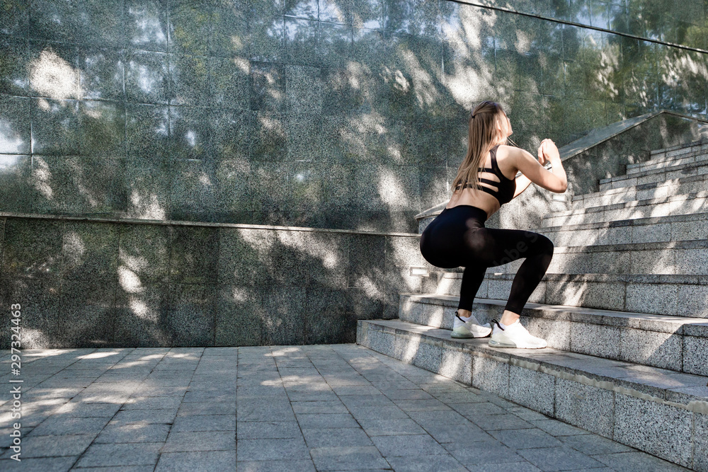 Sporty woman jumping while exercising. Sporty woman jumping while exercising.