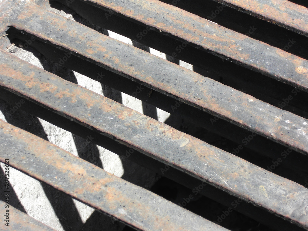 Close-up of the bars of a sewer drain, in Madrid, Spain Close-up of the bars of a sewer drain, in Madrid, Spain