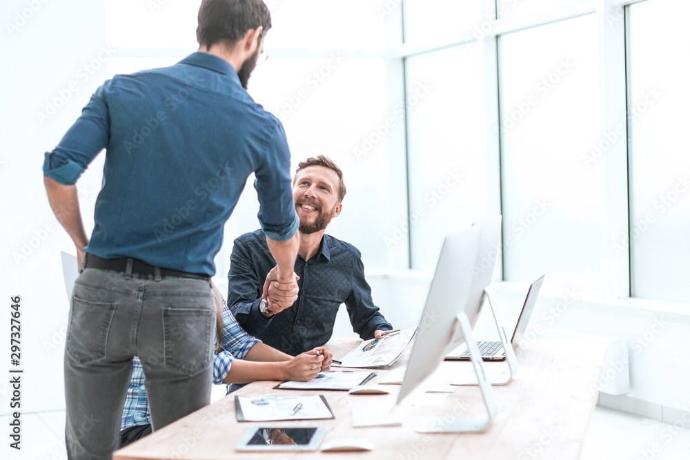 colleagues greet each other with a handshake. colleagues greet each other with a handshake.