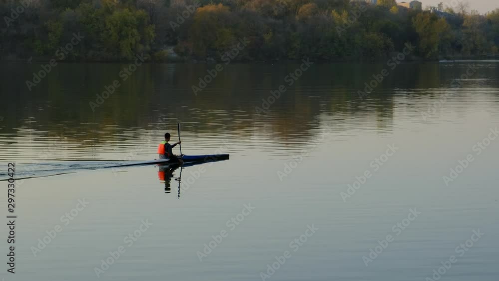 Athlete practicing rowing in a canoe or kayak Athlete practicing rowing in a canoe or kayak