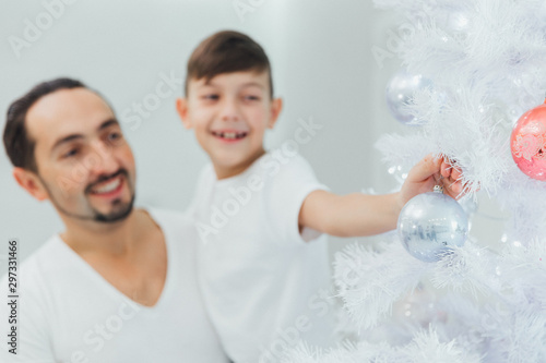 Happy Family Decorating Christmas Tree. Christmas time