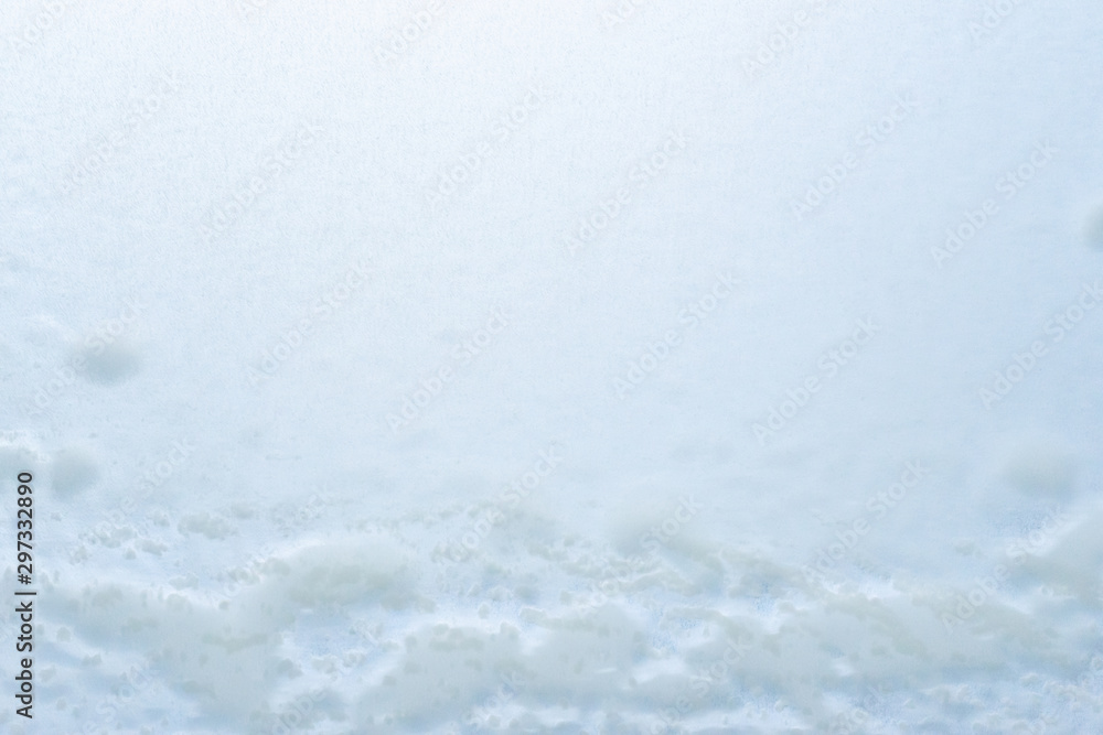 Obraz premium Abstract winter background, frozen glass covered with snow.