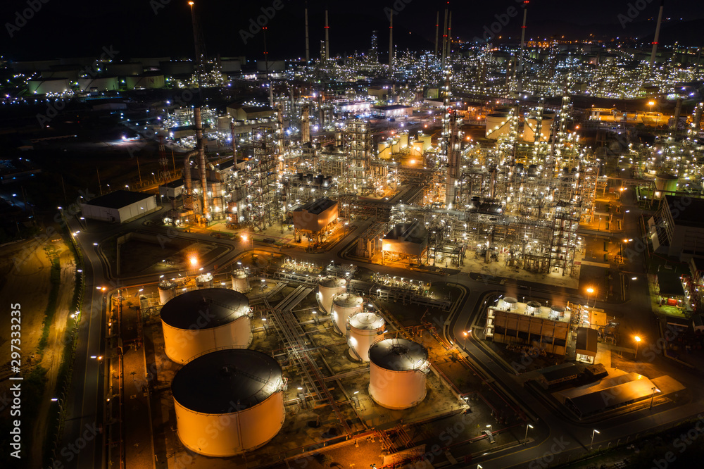 Aerial view oil storage tank with oil refinery factory industrial. Oil refinery plant at night. industry factory concept and transportation.