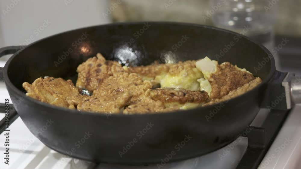 Making crispy fried roasted cauliflower in cast iron frying pan. Making crispy fried roasted cauliflower in cast iron frying pan.