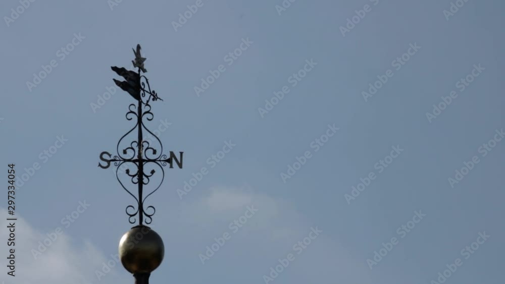 North-South Weathervane Isolated Cloudy Sky Copy Space On North Side North-South Weathervane Isolated Cloudy Sky Copy Space On North Side