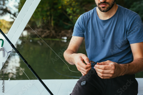 man fishing on river from his boat