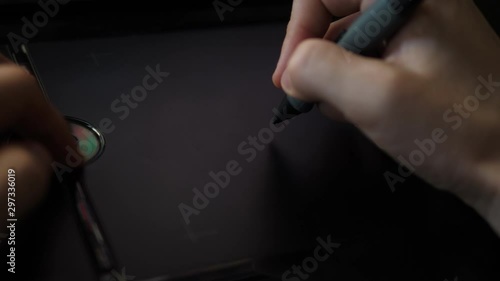 Freelance Artist working with Pen on digital graphic Tablet. POV Closeup Hand.