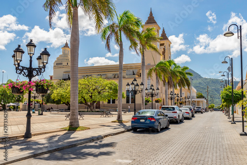 Caribbean old city street, church, independence square, tropical plants , palm tree, mountain view, Puerto Plata, Dominican Republic photo