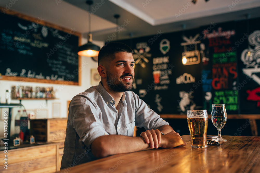 man sitting alone in beer pub
