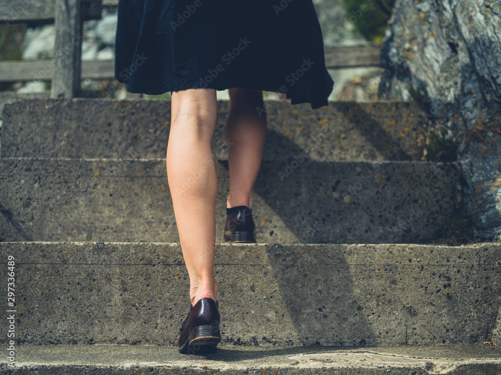 Legs of a young woman walking up some steps outside Legs of a young woman walking up some steps outside