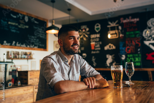 man sitting alone in beer pub