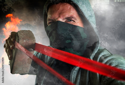 Photography young man as ultra and radical anarchist rioter