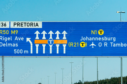 overhead road sign on highway