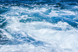 Rough sea or ocean foam. Blue salt water waves background.