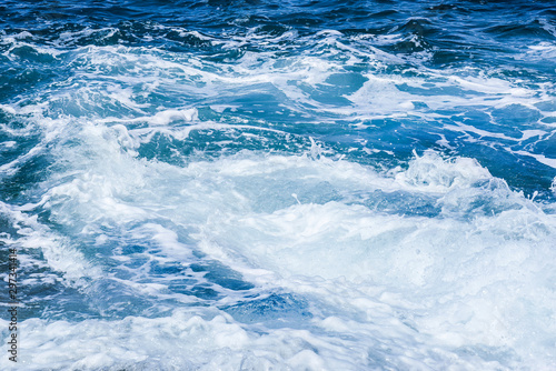 Rough sea or ocean foam. Blue salt water waves background.