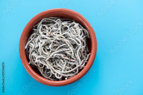 Fotografie Traditional Spanish food. Gulas with oil in ceramic dish.