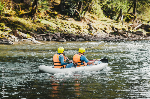 Two men in rubber boat. Rafting. Adventure travel.
