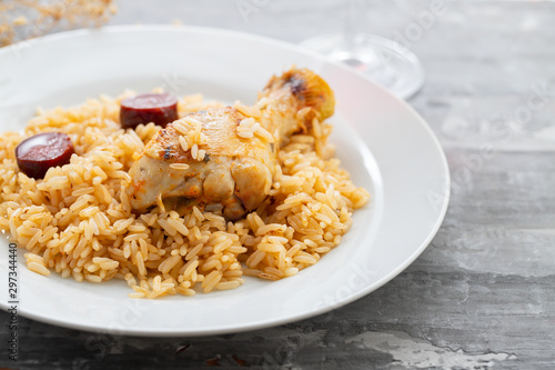 chicken with smoked sausage and rice on white plate