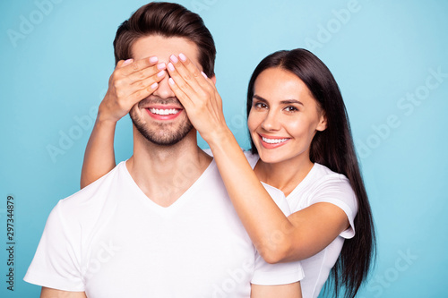 Close-up portrait of his he her she nice attractive charming lovely cute careful sweet cheerful couple girl closing guy's eyes isolated over bright vivid shine vibrant blue green turquoise background © deagreez