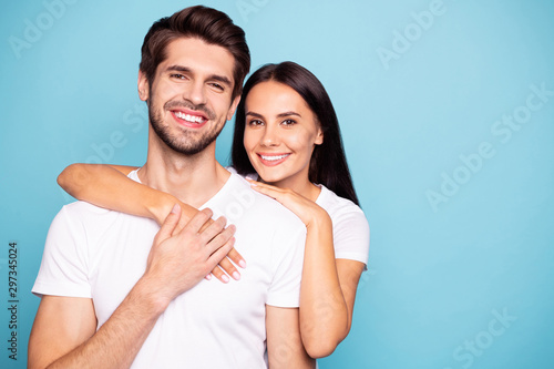 Close-up portrait of his he her she nice-looking attractive charming lovely cute sweet cheerful cheery couple hugging isolated over bright vivid shine vibrant blue green turquoise background