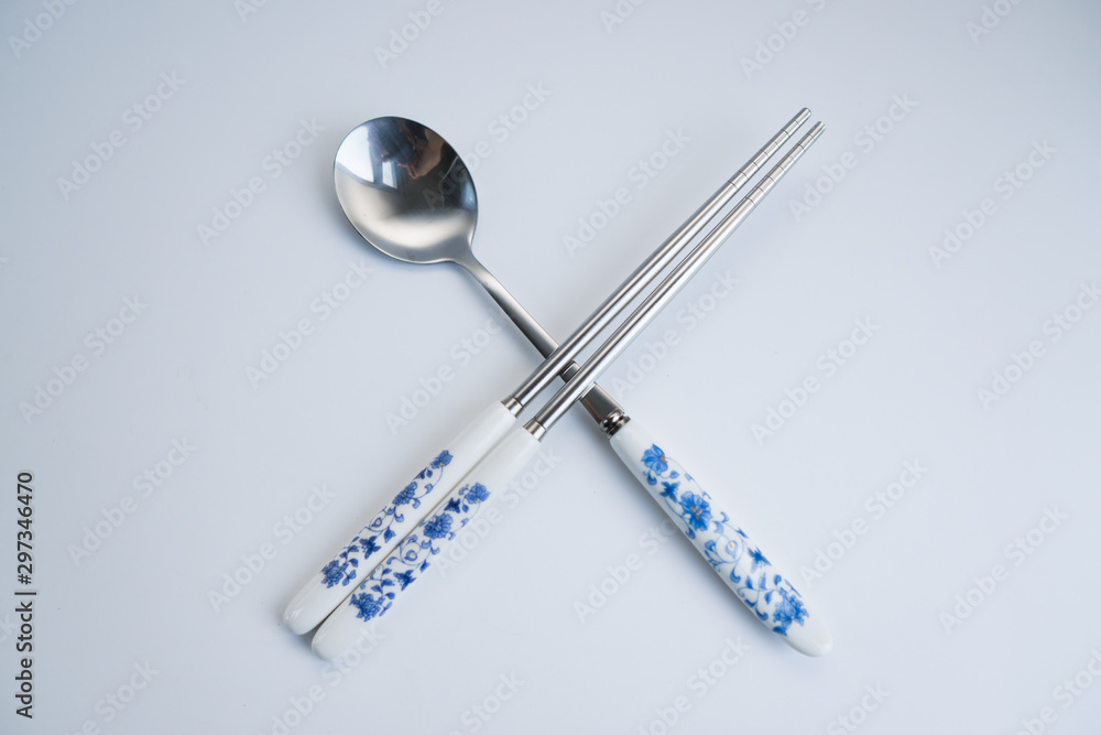 Set of chinese traditional cutlery spoon fork chopstick teaspoon with blue texture patern isolated on white background Set of chinese traditional cutlery spoon fork chopstick teaspoon with blue texture patern isolated on white background