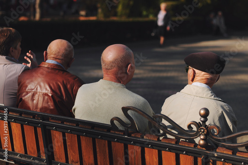 A senior  sitting on a bench