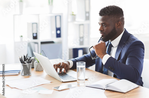 Принти на полотні Interested businessman checking new website for entrepreneurs