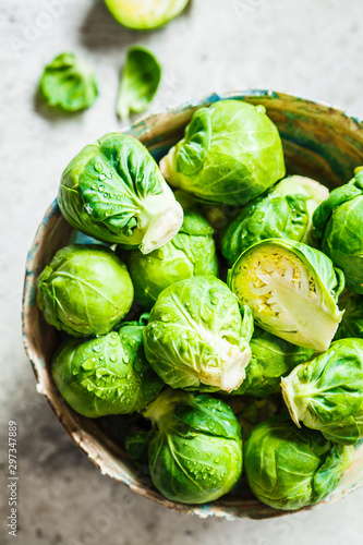 Canvas Print Raw brussels sprouts in bowl, gray concrete background, top view