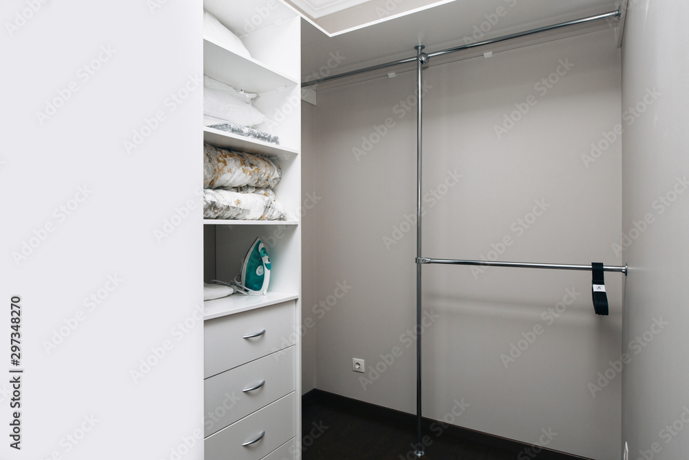 Open door to empty pantry room with white shelves and dark hardwood floor Open door to empty pantry room with white shelves and dark hardwood floor