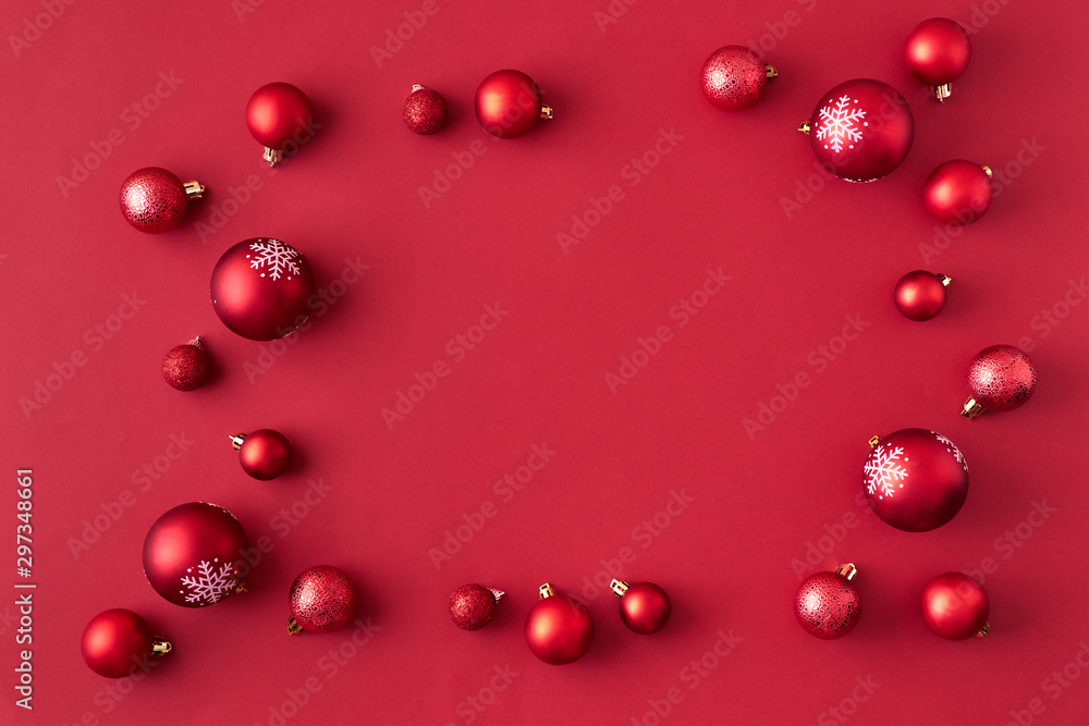 Flat lay frame with red christmas balls on a red background Flat lay frame with red christmas balls on a red background
