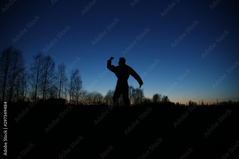 man silhouette in sunset time in a field