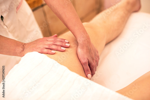 Massaging a thigh of a strong man © didesign