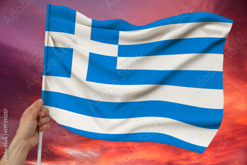 National flag of the country Greece on delicate silk with wind folds, travel concept, immigration, politics, copy space, close-up
