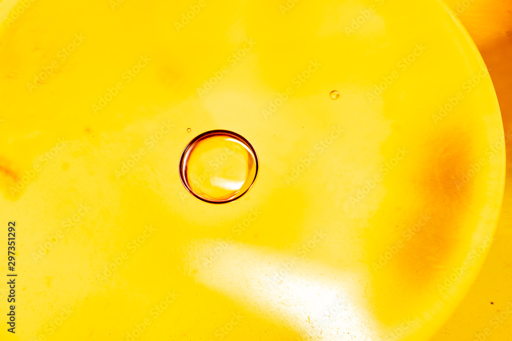 Abstract colorful background. Foam of Soap with Bubbles macro shot. Closeup bubbles in water. Oil drops on a water surface abstract background. Golden yellow bubble.Yellow water bubbles wallpaper