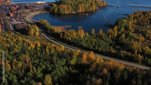 Aerial view of the autumn forest with lakes and rivers. Aerial view of colorful fall foliage in Sweden. Swedish natural landscapes in the autumn season and village.