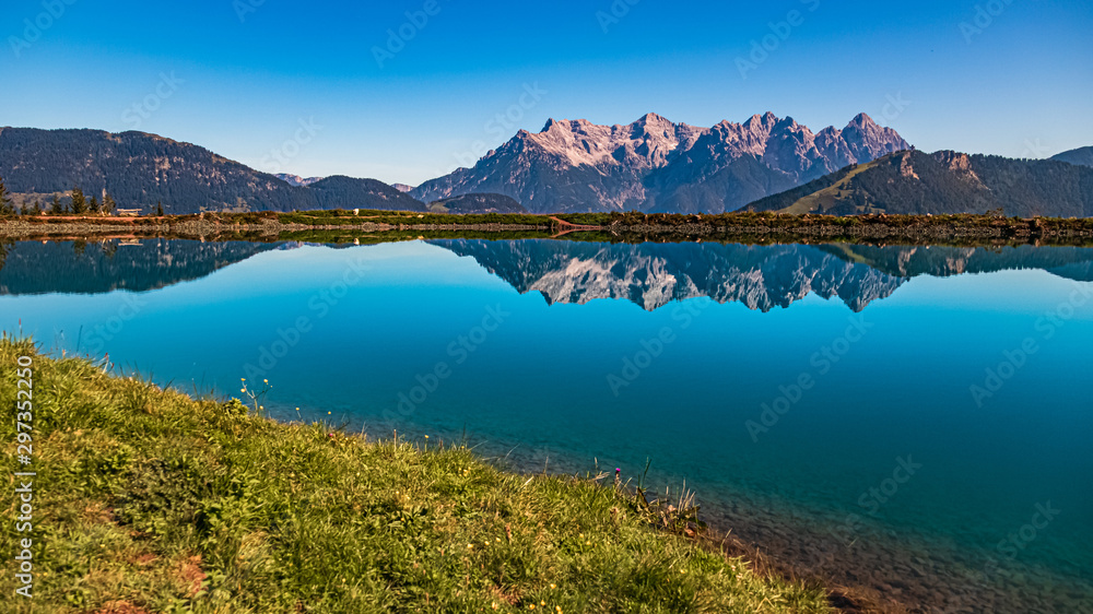 Beautiful alpine view with reflections in a lake at Fieberbrunn, Tyrol, Austria
